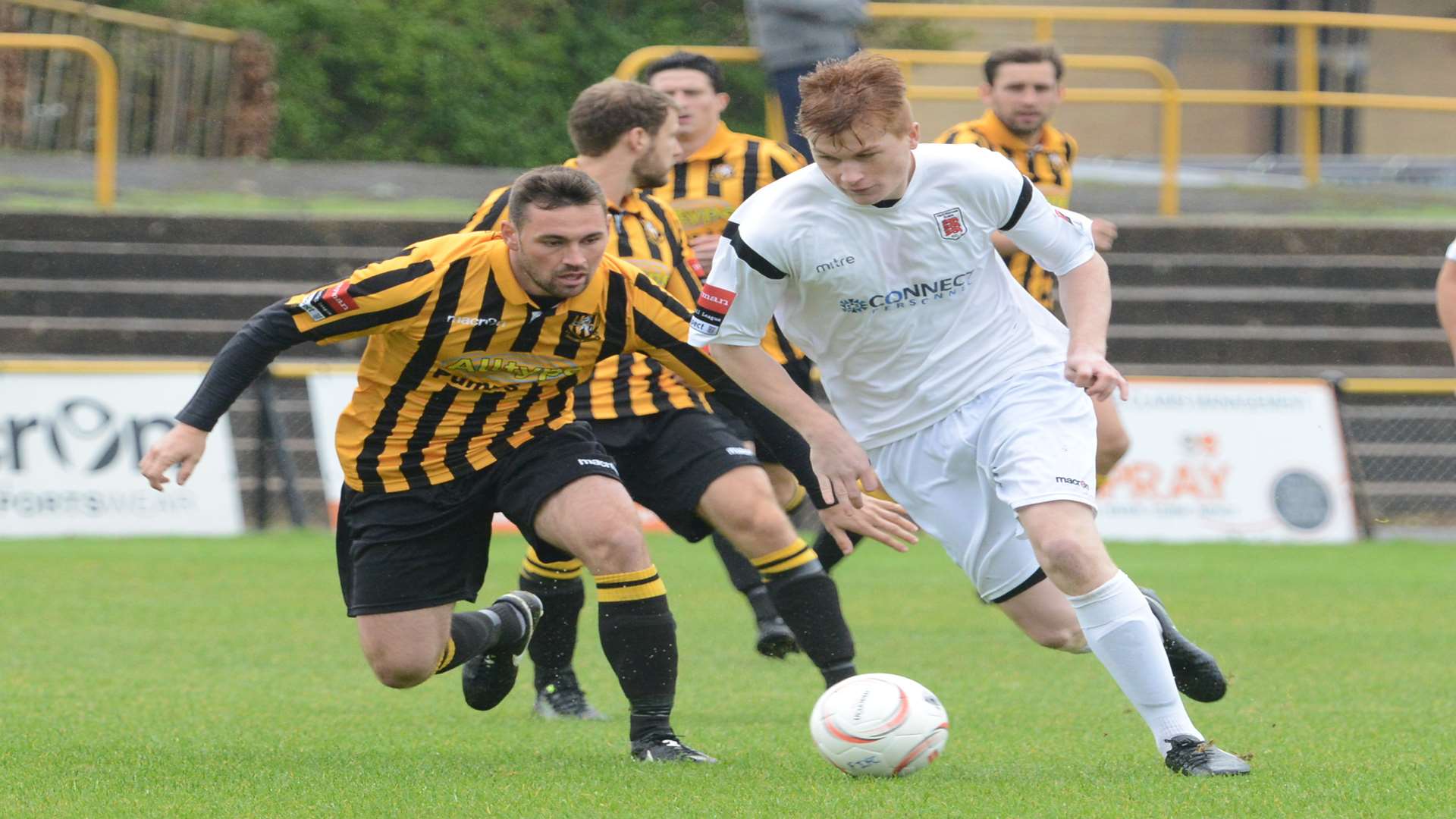 Charley Robertson takes on Ronnie Dolan during Faversham's 2-0 win at Folkestone Picture: Gary Browne