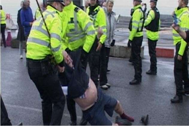 Reg Bell being held by police during the protest at Ramsgate in 2014. Picture: Mike Pett