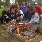 Campers toast dough on the fire at Hall Place in Leigh, Tonbridge. Picture: STEVE CRISPE