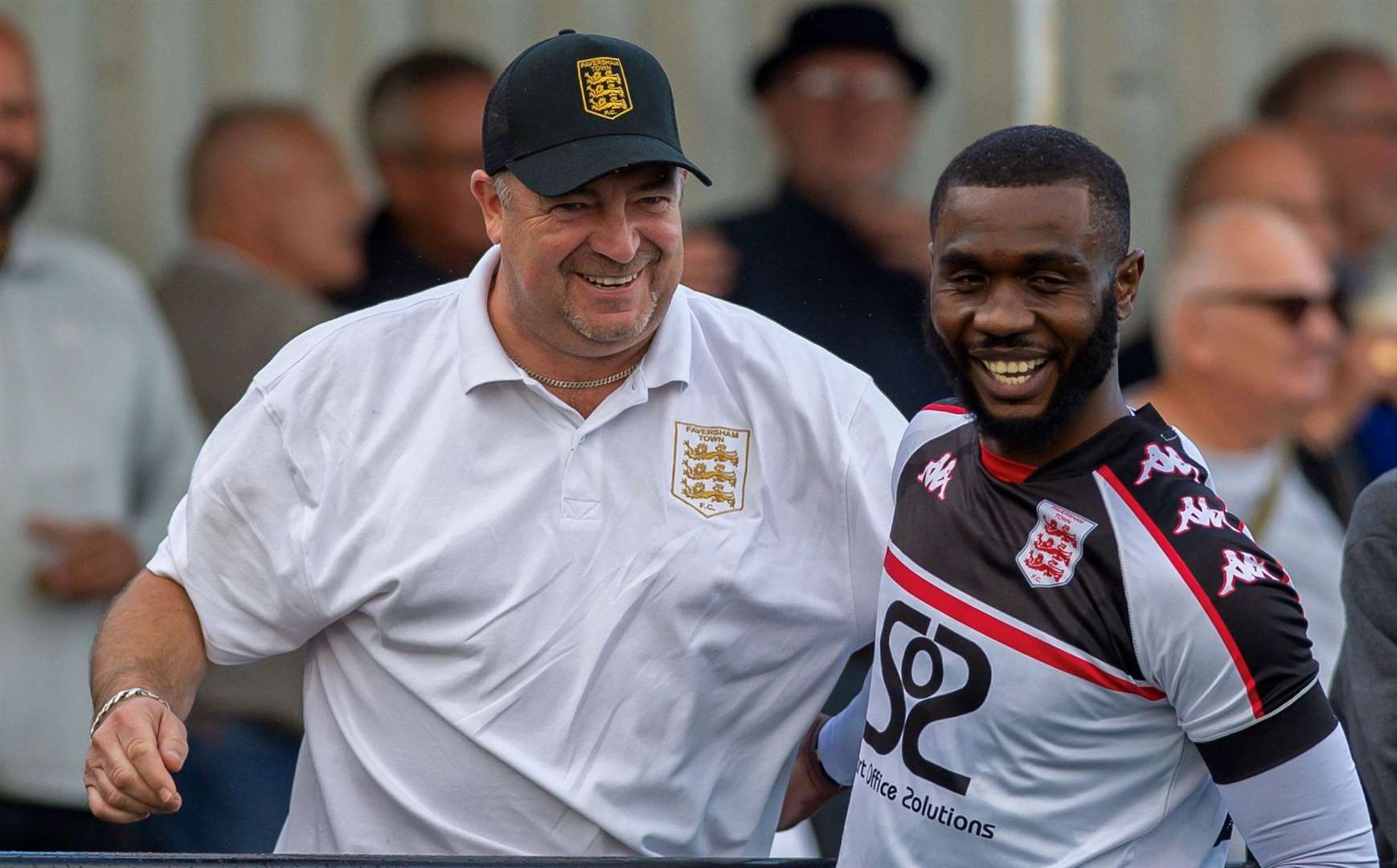 Warren Mfula celebrates one of his two goals with Faversham vice-chairman Marc Leader. Picture: Ian Scammell