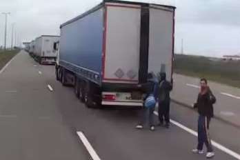 Illegal immigrants look for lorries to hide in at Calais