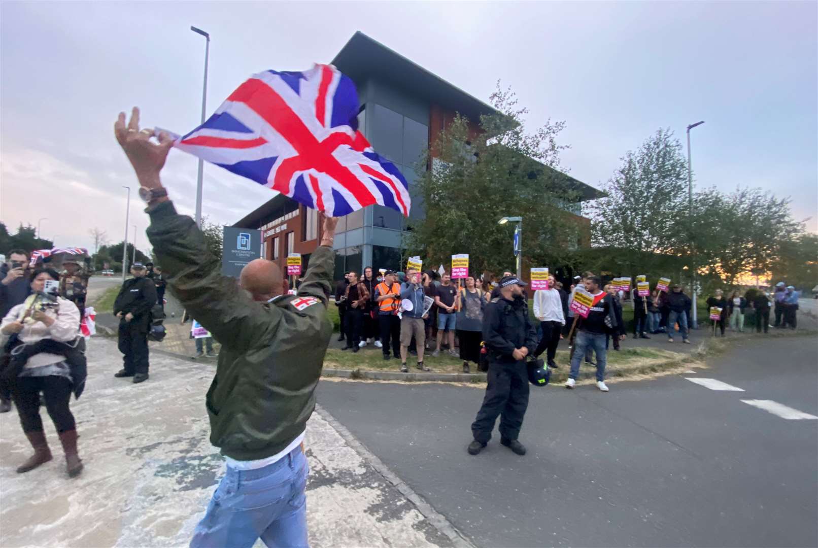 A man waving a Union Jack in front of anti-racism protesters was moved away by police