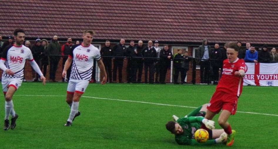 Deal keeper Henry Newcombe dives at the feet of a home player. Picture: John Anderson