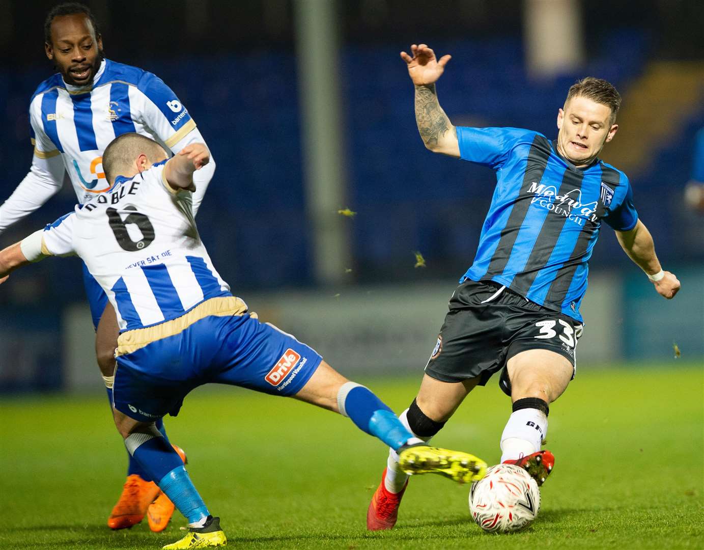 Gillingham's Mark Byrne at full stretch against Liam Noble. Picture: Ady Kerry