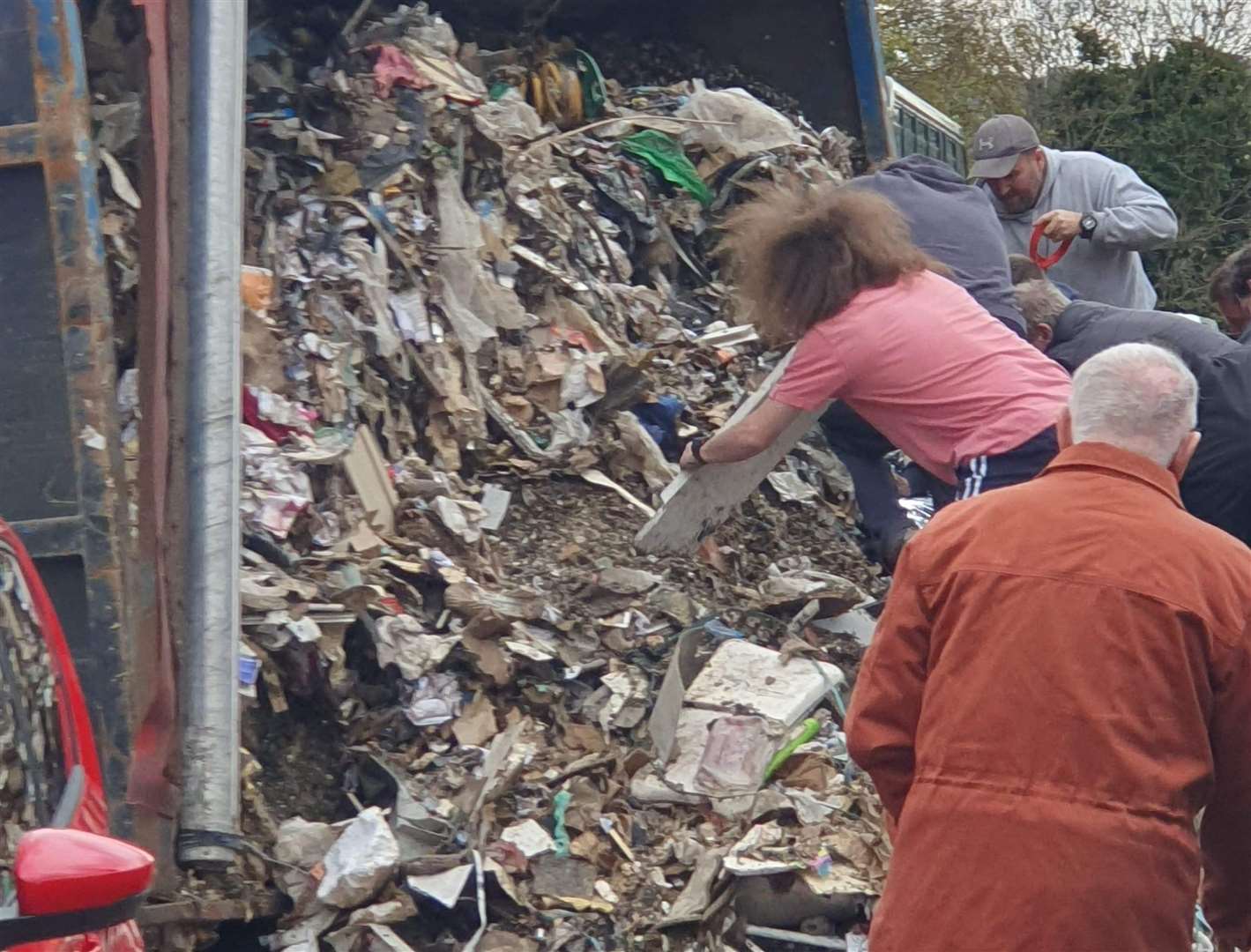 Passer-bys attempted to clear rubble from the tipped over lorry. Picture: Clint Else