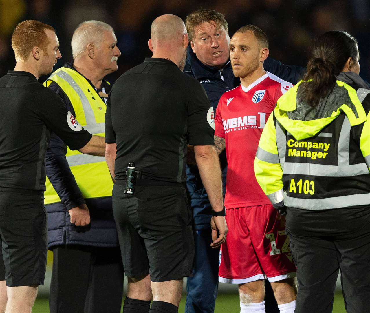 Barry Fuller and assistant boss Paul Raynor in discussion with referee Kevin Johnson at AFC Wimbledon on Saturday Picture: Ady Kerry