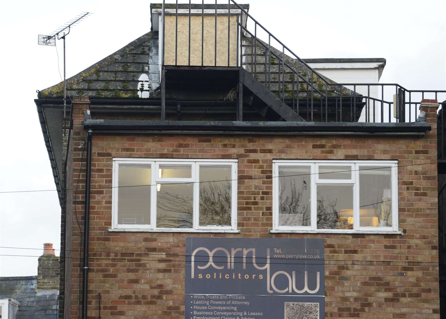 The boarded up window at Parry Law Solicitors