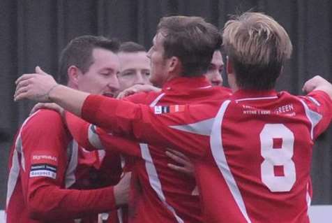 Shaun Welford, left, takes the congratulations from his team-mates after scoring for Hythe against Faversham on Saturday (Pic: Paul Amos)