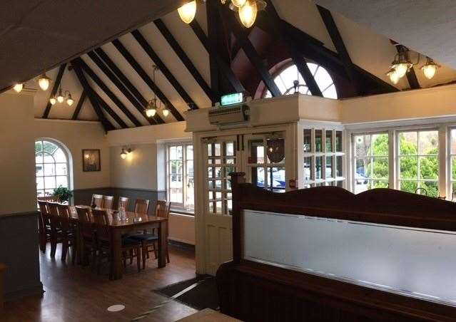 To the right hand side of the entrance is a large dining table which can accommodate eight diners, to the left there is another large dining table bordered by a pew