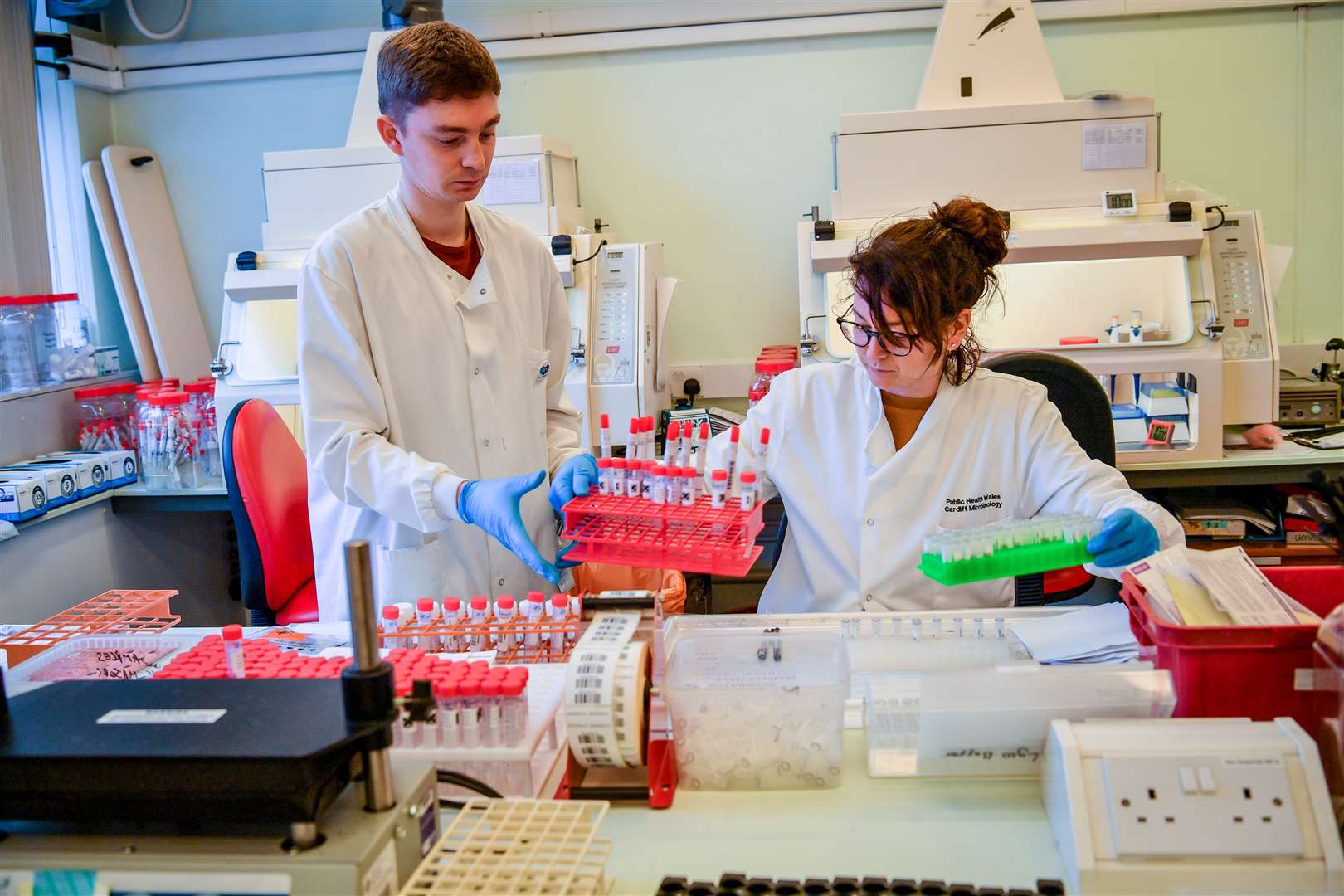 Lab technicians at the Specialist Virology Centre at the University Hospital of Wales (Ben Birchall/PA)