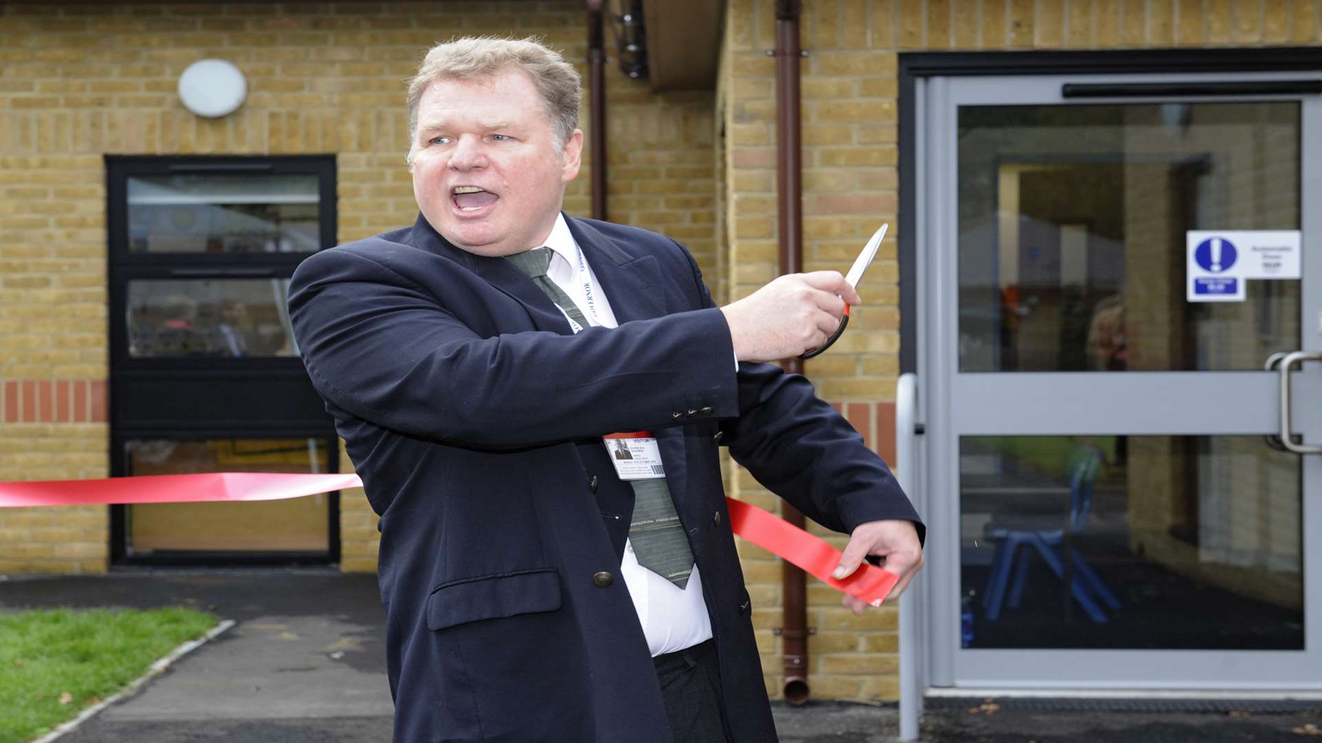 George Box cutting the ribbon to open the annex