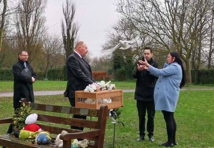 Luchii's parents release a dove at the funeral