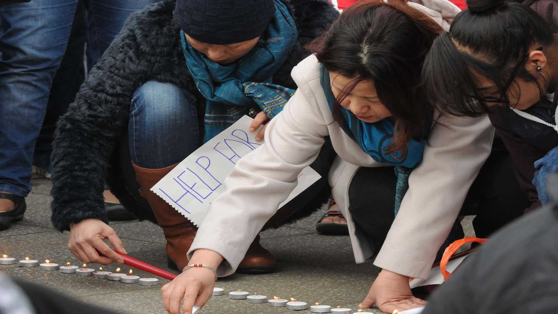 Tea lights spelling Pray for Nepal were lit and laid on the ground