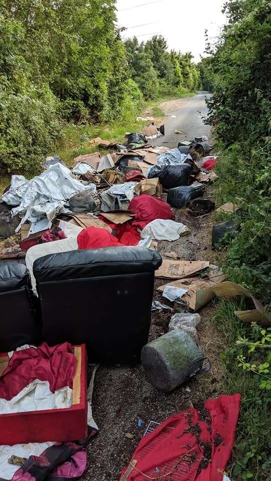 A black leath sofa and multiple rubbish bags were dumped in Downs Road, near Gravesend Picture: Richard Rushen (13716209)