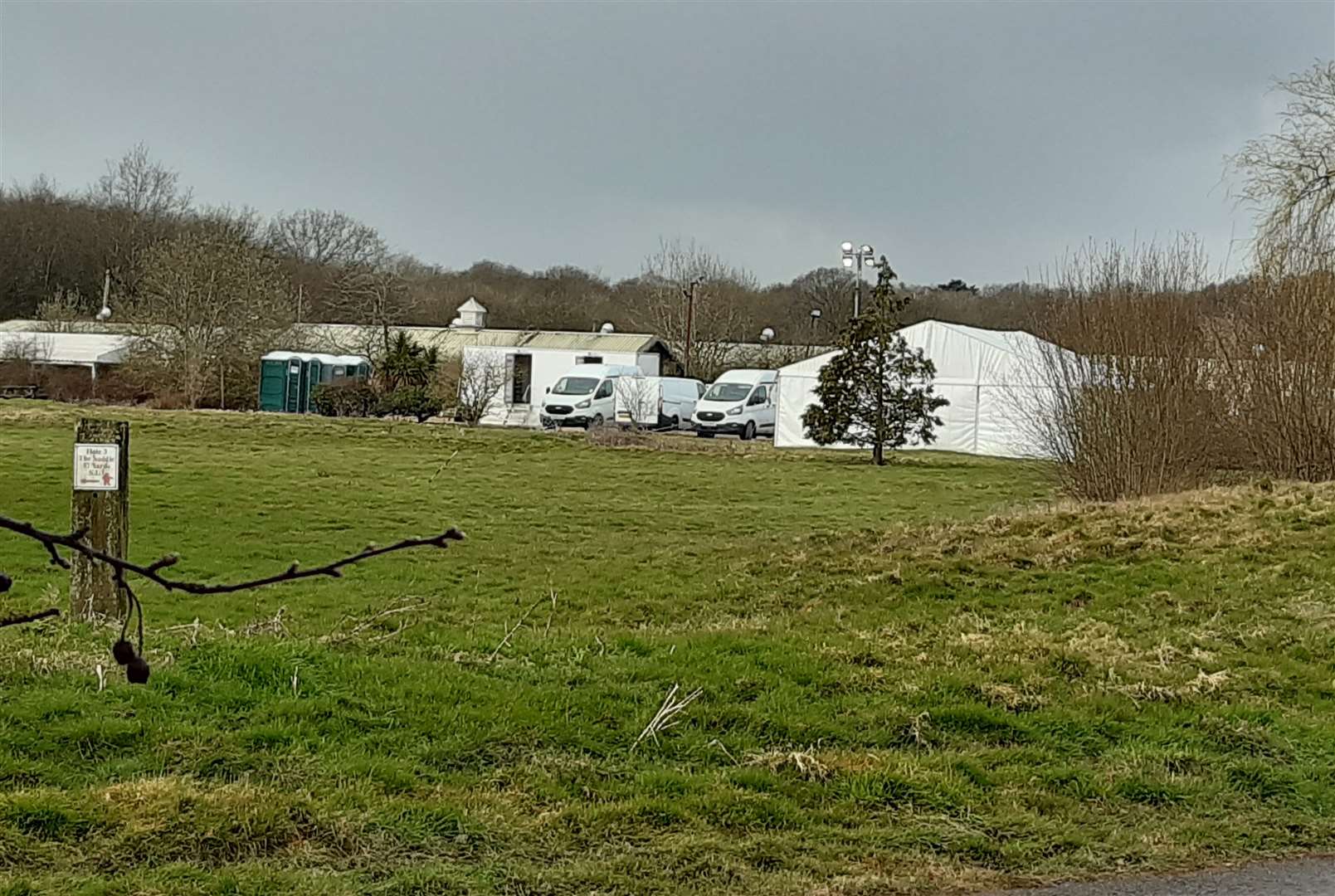 Police vehicles are parked next to the site's former driving range