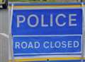 Man injured as two car crash closes road 