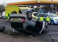 Road shut after car flips on roundabout