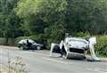 Road blocked after car ends up on roof in crash