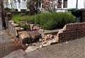 Car hits walls in front of houses