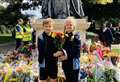 School children lay flowers for the Queen