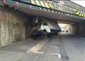 Wedged van closes road