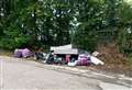 Furniture and bin bags dumped in country lane