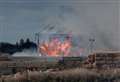 Fire crews battle barn blaze for third day as smoke blows across road