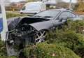 Mystery over crumpled sports car wedged into retail sign