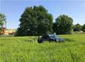 Car lands in field after crash on M2