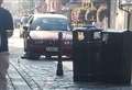 BMW’s wheels left spinning in the air after getting stuck on bollards