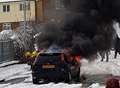 Car alight as it battles through snow 