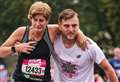 Stranger helps leg-break runner over finish line