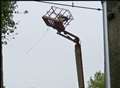 Workers stuck for two hours after cherry-picker topples