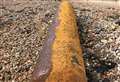 Large rusty object washes up on beach