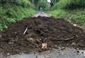 Dumped mud blocks road