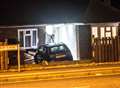 Woman arrested after car smashes into house 