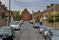 Road closed after car crashes into parked vehicle