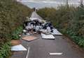 Huge pile of fly-tipped waste blocks road