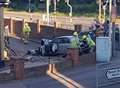 Car crashes through railings and wall