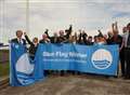 Beach hoists blue flag 