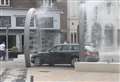 Cheeky driver uses town's new water feature for free car wash