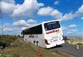 Road closed as tourist coach stuck in shingle