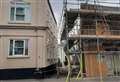 Scaffolding hangs off building in strong winds