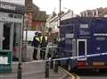 Gun threat to woman guard outside bank