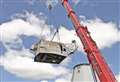 Historic mill's renovated cap lifted into place after five years