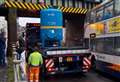 Delays after tank strapped to lorry hits railway bridge