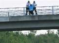 Young man threatens to leap from bridge