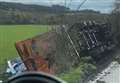 Lorry overturns and crashes onto path 