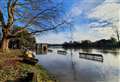 Park lake floods footpaths after weather warning