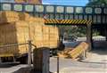 Straw bales fall from tractor’s trailer onto busy route